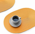 FunWheat Oval Braided Placemats Set of 4 Table Mats for Dining Tables Washable Heat Resistant Place Mats for Indoor Outdoor Use 12 x18 Inch(Oval Pumpkin Yellow, 4pcs)